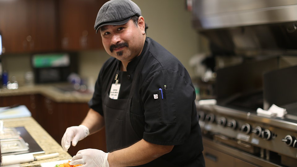 senior living cafe manager in kitchen