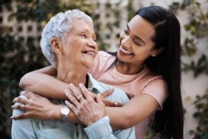 senior mother and daughter smiling during the process of moving a parent to memory care