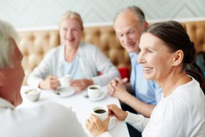 a group of people sit around a table having coffee which is just one of the types of group outings