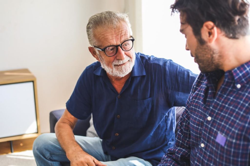 a person talks to a senior asking questions for assisted living
