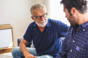 a person talks to a senior asking questions for assisted living