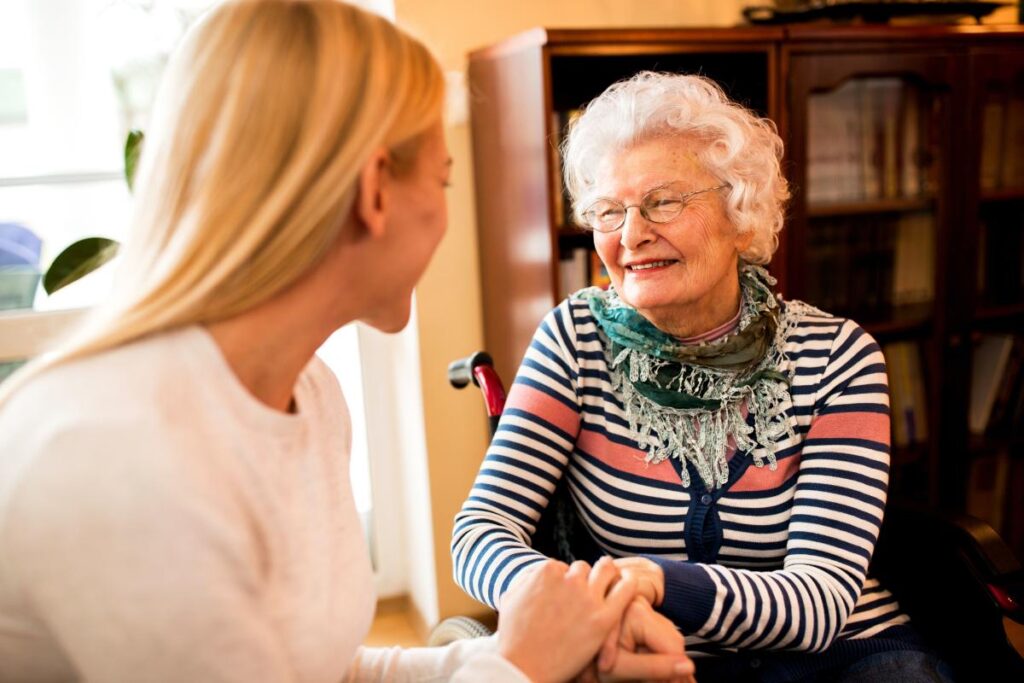 smiling older woman and daughter engaging in activities for seniors with limited mobility