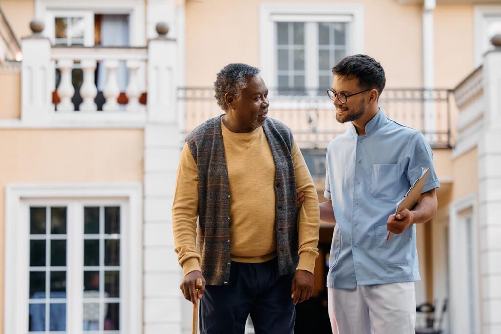 Caretaker and elderly man taking a walk as exemplary of long-term skilled nursing qualifications for seniors