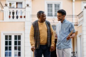 Caretaker and elderly man taking a walk as exemplary of long-term skilled nursing qualifications for seniors