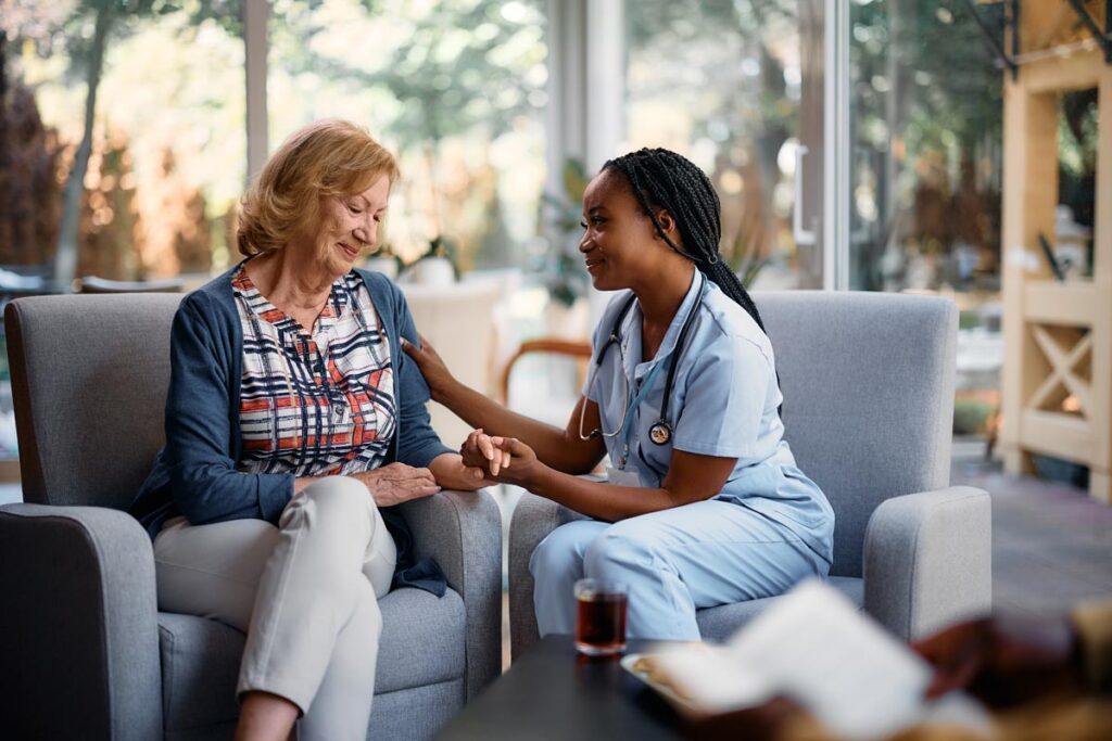 Caregiver and senior woman discussing the average cost of memory care in Texas