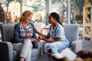 Caregiver and senior woman discussing the average cost of memory care in Texas
