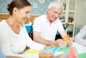 Two people trying out craft ideas for the elderly