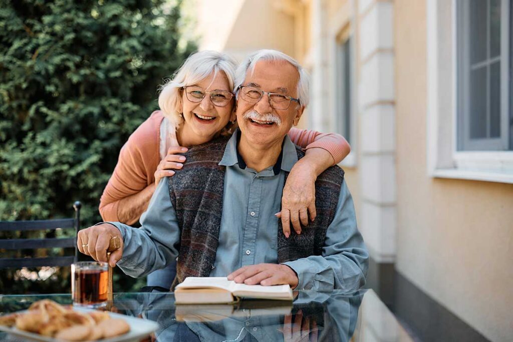 Older couple embracing and smiling after finding answers to the question are independent living communities regulated