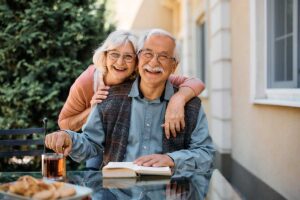 Older couple embracing and smiling after finding answers to the question are independent living communities regulated