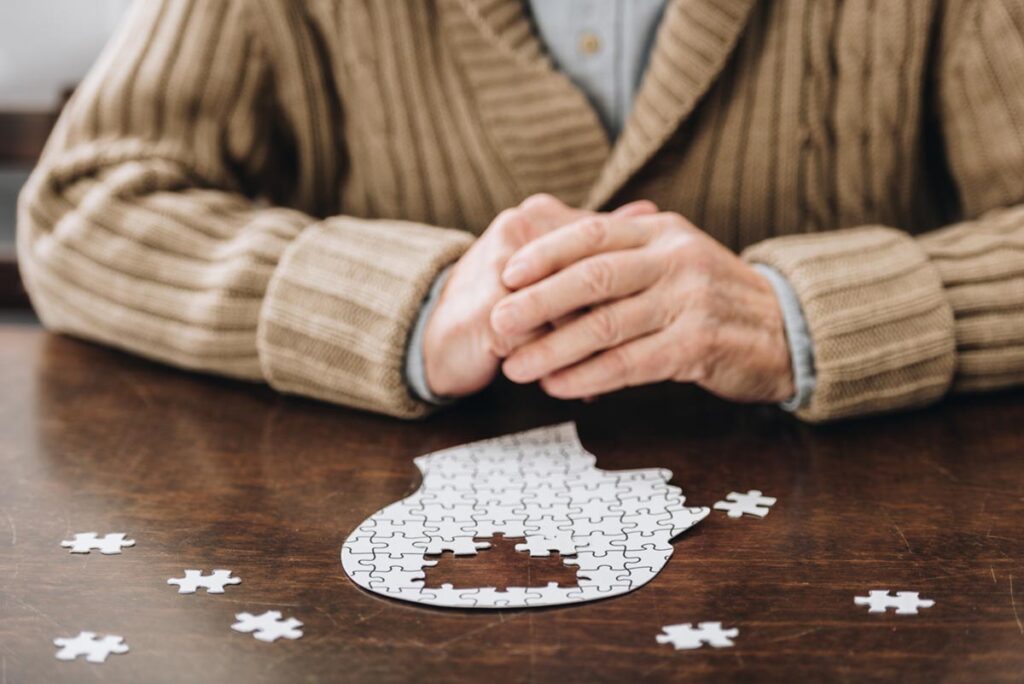 Hands of a person wondering how Alzheimer's affects the brain