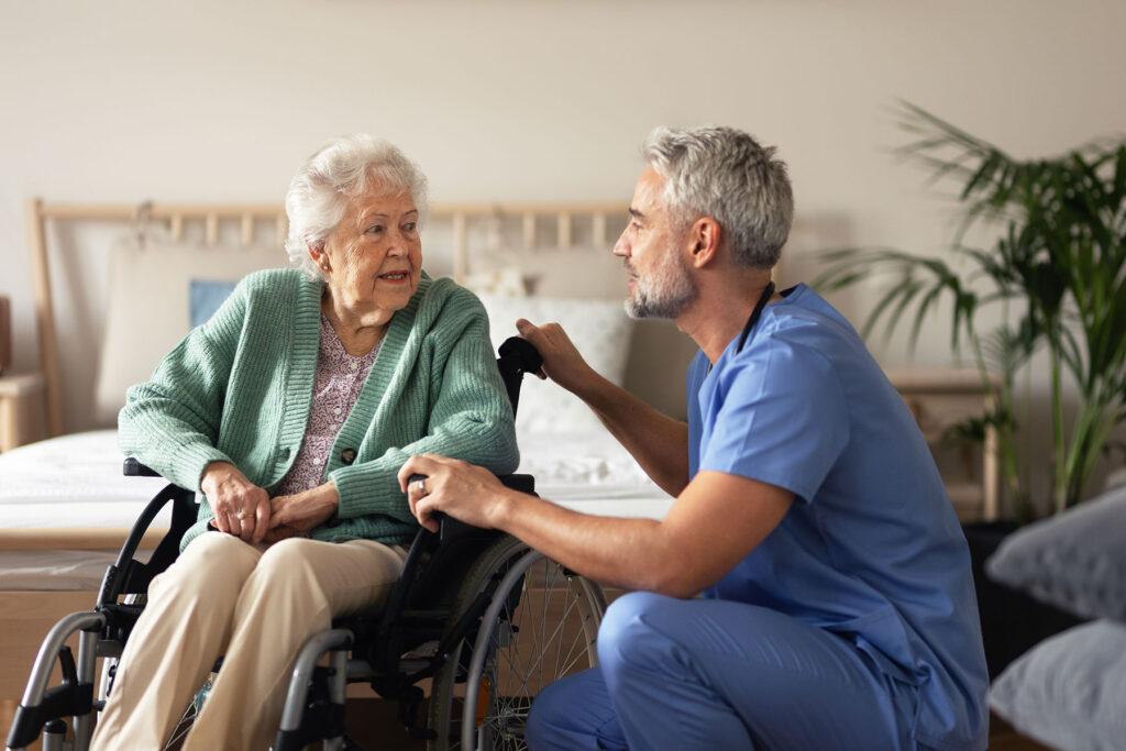 compassionate caretaker and happy older woman discussing answers to the question are assisted living programs safe