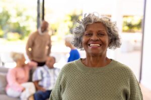 person smiling in outdoor area of senior living community after learning about what is independent living for seniors