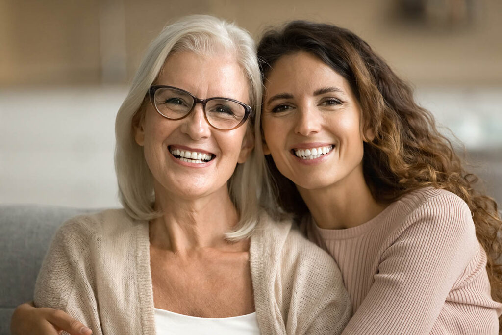 adult daughter and senior mother smiling after finding answers to the question who is respite care best suited for