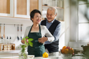 happy seniors cooking in kitchen after choosing assisted living select