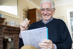 older man reading about latest research and advances in alzheimers and dementia care