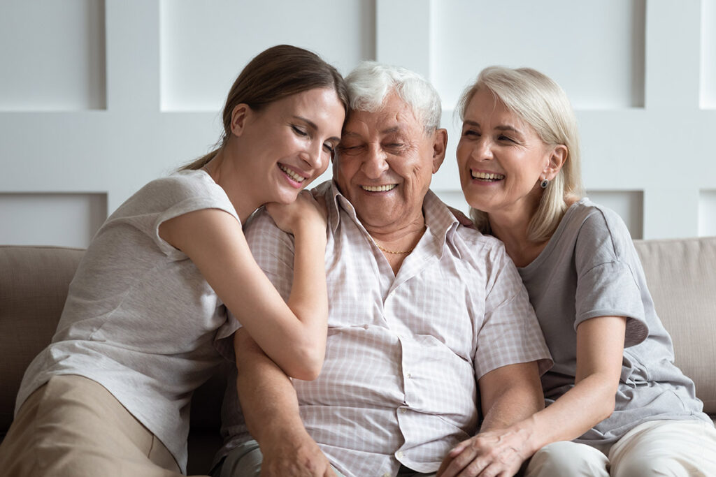 daughters spending quality time with father after placing a parent in memory care