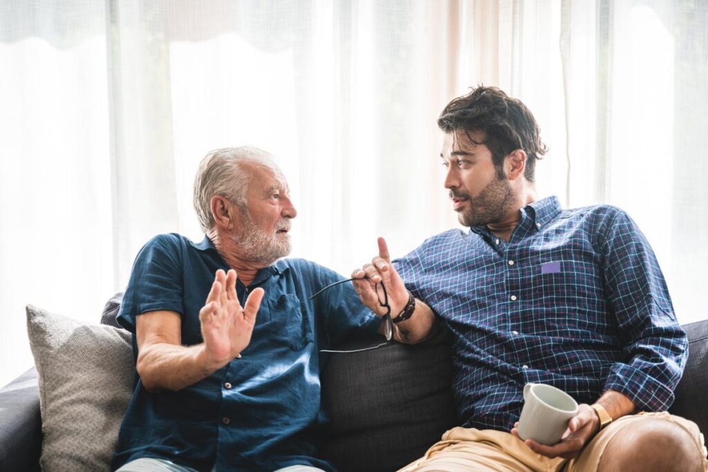 father and son discussing answers to senior living faq